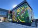 Eye-catching floral mural on the exterior of a modern building adding an artistic flair to the neighborhood at 888 S Valentia St # 103, Denver, CO 80247