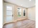 Bright and airy office space featuring wood-look floors, a frosted glass door, and modern trim details at 888 S Valentia St # 103, Denver, CO 80247