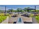 Outdoor seating area with tables, chairs, umbrellas and planters, and a fire pit at 888 S Valentia St # 103, Denver, CO 80247