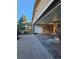 Attached garage with open door and concrete floor and shelving in a home with front garden and covered porch at 1883 S Pierce St, Lakewood, CO 80232