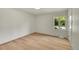 Bright, light filled, bedroom featuring a large window and hardwood flooring at 3736 S Hibiscus Way, Denver, CO 80237
