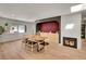 Bright dining room with hardwood floors, a modern fireplace, and a built-in wet bar perfect for entertaining at 3736 S Hibiscus Way, Denver, CO 80237