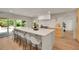 Modern kitchen features an oversized island with seating, stainless steel appliances, and abundant natural light at 3736 S Hibiscus Way, Denver, CO 80237