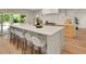 Bright kitchen boasts a large island with seating and sleek countertops, perfect for entertaining and modern living at 3736 S Hibiscus Way, Denver, CO 80237