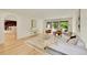 Bright living room with a large sectional, modern decor, and access to the backyard through sliding glass doors at 3736 S Hibiscus Way, Denver, CO 80237