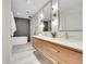 Modern main bathroom with dual vanities, stylish lighting, and a freestanding soaking tub in the tiled shower area at 3736 S Hibiscus Way, Denver, CO 80237