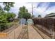 Fenced backyard with garden beds, shed and landscaped area at 4416 Brentwood St, Wheat Ridge, CO 80033