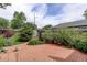 Picturesque backyard features a brick patio, lush greenery, and inviting outdoor seating area at 4416 Brentwood St, Wheat Ridge, CO 80033
