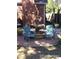 Inviting backyard patio with a charming water fountain and ample outdoor seating at 4416 Brentwood St, Wheat Ridge, CO 80033
