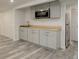 Charming basement kitchenette with new cabinets, stainless steel appliances, and wood look floors at 4416 Brentwood St, Wheat Ridge, CO 80033