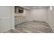 The basement kitchen features modern appliances, a wood-look countertop, and gray shaker cabinets at 4416 Brentwood St, Wheat Ridge, CO 80033