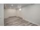 Spacious finished basement with recessed lighting, baseboard heaters, and modern vinyl plank flooring at 4416 Brentwood St, Wheat Ridge, CO 80033