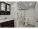 The modern bathroom boasts sleek design elements, including a glass-enclosed shower and stylish vanity at 4416 Brentwood St, Wheat Ridge, CO 80033