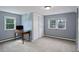 Cozy bedroom with ample natural light, neutral carpet, and built-in closet for efficient storage at 4416 Brentwood St, Wheat Ridge, CO 80033
