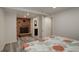 Comfortable bedroom features a brick fireplace, wood look floors, and access to an en suite bathroom at 4416 Brentwood St, Wheat Ridge, CO 80033