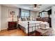Cozy primary bedroom with hardwood floors, a ceiling fan, and large windows for natural light at 4416 Brentwood St, Wheat Ridge, CO 80033