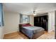 Comfortable bedroom with a full size bed, ceiling fan and a built in closet and TV at 4416 Brentwood St, Wheat Ridge, CO 80033