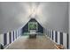 Attic bonus room, perfect for a playroom, features unique striped accent walls and a cozy reading nook at 4416 Brentwood St, Wheat Ridge, CO 80033