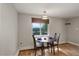 Cozy dining area features hardwood floors, a round table set for two, and a window with lovely mountain views at 4416 Brentwood St, Wheat Ridge, CO 80033