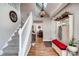 Inviting entryway with hardwood floors, coat rack, and stairway leading to the upper level at 4416 Brentwood St, Wheat Ridge, CO 80033