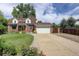 Charming brick home featuring a well-manicured lawn and a two-car garage at 4416 Brentwood St, Wheat Ridge, CO 80033