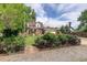 Beautiful home featuring mature landscaping with flower beds and a charming front gate at 4416 Brentwood St, Wheat Ridge, CO 80033