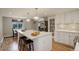 Bright kitchen with white cabinets, a spacious island, and stainless steel appliances at 4416 Brentwood St, Wheat Ridge, CO 80033