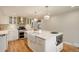 Modern kitchen with stainless steel appliances, a farmhouse sink and a kitchen island at 4416 Brentwood St, Wheat Ridge, CO 80033