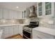 Modern kitchen featuring updated appliances and stylish cabinetry with a white brick backsplash at 4416 Brentwood St, Wheat Ridge, CO 80033