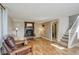 Inviting living room with hardwood floors, a fireplace, and staircase at 4416 Brentwood St, Wheat Ridge, CO 80033