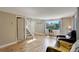 Bright living room with hardwood floors, large windows, and staircase at 4416 Brentwood St, Wheat Ridge, CO 80033