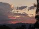 Cloudscape view of a sunset featuring pink and purple clouds over mountain silhouettes at 4416 Brentwood St, Wheat Ridge, CO 80033