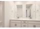 Modern bathroom with dual sinks, modern countertops, and white cabinetry for ample storage at 645 Flintwood Pl, Lafayette, CO 80026