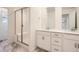 Spacious bathroom with glass-enclosed shower, dual sinks, and modern vanities at 645 Flintwood Pl, Lafayette, CO 80026