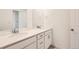 Well-lit bathroom with dual sinks, modern countertops, and white cabinetry for ample storage at 645 Flintwood Pl, Lafayette, CO 80026