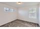 A bright bedroom with carpet and two windows lets in ample natural light at 645 Flintwood Pl, Lafayette, CO 80026