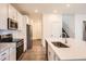 A bright kitchen features an island with a sink, stainless steel appliances, and hardwood floors at 645 Flintwood Pl, Lafayette, CO 80026