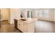 Modern kitchen island with stainless steel sink and white cabinets, perfect for food preparation and dining at 645 Flintwood Pl, Lafayette, CO 80026