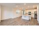 Bright open kitchen with a white island with modern flooring and stainless steel appliances at 645 Flintwood Pl, Lafayette, CO 80026