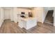 Bright, open kitchen with stainless steel appliances, large island, and modern white cabinetry at 645 Flintwood Pl, Lafayette, CO 80026