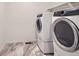 A laundry room with updated machines and durable tile flooring at 645 Flintwood Pl, Lafayette, CO 80026