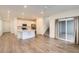 Open-concept living space with modern flooring, recessed lighting, and kitchen island, great for entertaining at 645 Flintwood Pl, Lafayette, CO 80026