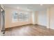 Bright living room featuring modern flooring, large windows, and a ceiling fan at 645 Flintwood Pl, Lafayette, CO 80026