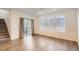 Bright living room featuring modern flooring, large windows, and a sliding door leading to a deck at 645 Flintwood Pl, Lafayette, CO 80026