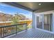 A covered patio has wood decking with railing and view of other residences at 645 Flintwood Pl, Lafayette, CO 80026