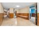 Finished basement showcasing a long bench, tile floor, and wood paneled walls at 5285 E Iliff Ave, Denver, CO 80222