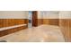Basement hallway with knotty pine wainscoting, tile floors and built in bench seat at 5285 E Iliff Ave, Denver, CO 80222