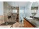 Stylish bathroom with modern tiling, a glass-enclosed shower, and a vanity with stone countertop at 5285 E Iliff Ave, Denver, CO 80222