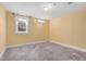 Bedroom with yellow walls, gray carpeting, and a double window at 5285 E Iliff Ave, Denver, CO 80222