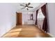 A bright and spacious bedroom featuring hardwood floors, a ceiling fan, and generous natural light at 5285 E Iliff Ave, Denver, CO 80222